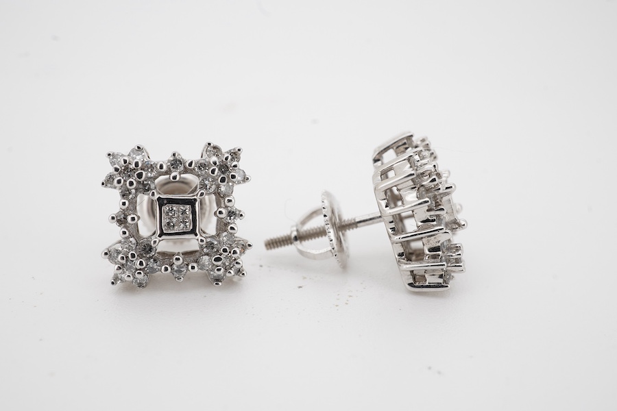 A pair of diamond earrings, each designed as an openwork square cluster, set with single-cut and princess-cut diamonds, length 1.1cm each, post fittings, stamped 14K, combined gross weight 3 grams, Condition: good